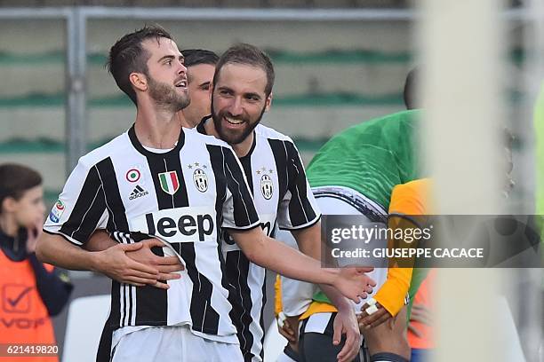 Juventus' midfielder from Bosnia Miralem Pjanic celebrates with teammate Juventus' forward from Argentina, Gonzalo Higuain, after scoring during the...