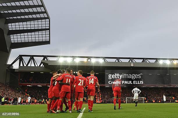 Liverpool players mob Liverpool's Senegalese midfielder Sadio Mane after he scored the team's fifth goal during the English Premier League football...