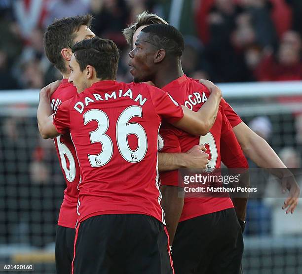 Paul Pogba of Manchester United celebrates scoring their first goal during the Premier League match between Swansea City and Manchester United at the...