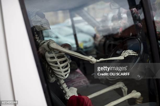 Skeleton is pictured in the driving seat of a parked minibus during the biannual 'Whitby Goth Weekend' festival in Whitby, northern England, on...