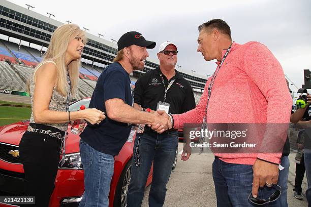 Actor Chuck Norris greets Texas Rangers Manager Jeff Banister as Gena O'Kelley and former Tampa Bay Devil Rays relief pitcher Jim Morris look on...