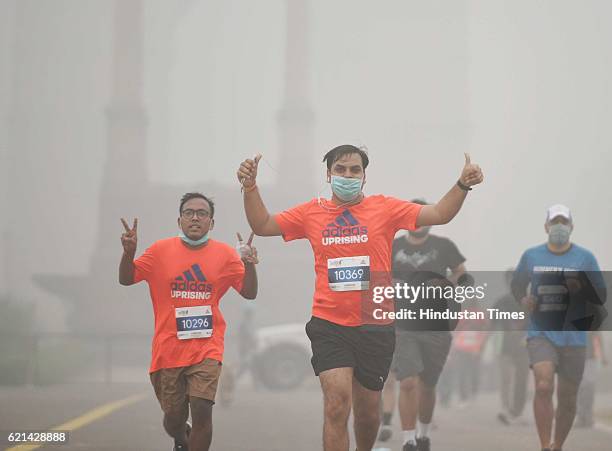 People jogging in a foggy morning at India Gate as smog covers the capital's skyline, on November 6, 2016 in New Delhi, India. New Delhi's air...