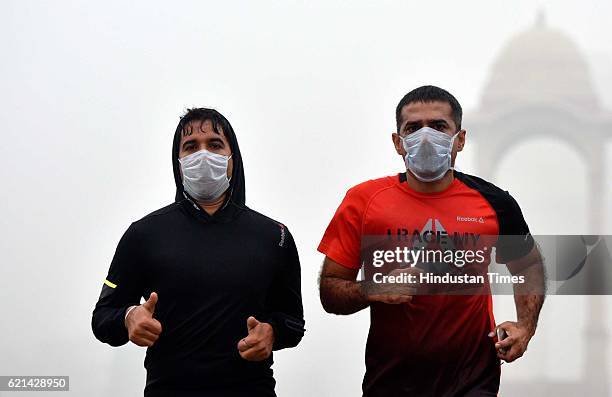 People jogging in a foggy morning at India Gate as smog covers the capital's skyline, on November 6, 2016 in New Delhi, India. New Delhi's air...