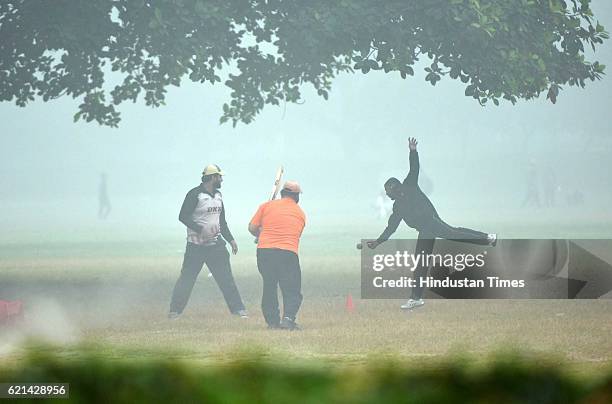 People play in a foggy morning at India Gate as smog covers the capital's skyline, on November 6, 2016 in New Delhi, India. New Delhi's air quality...