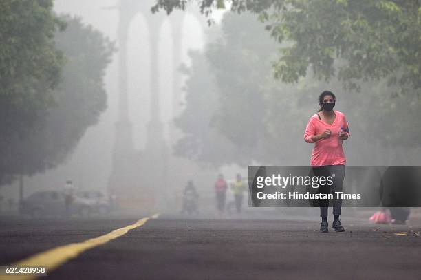 People jogging in a foggy morning at India Gate as smog covers the capital's skyline, on November 6, 2016 in New Delhi, India. New Delhi's air...