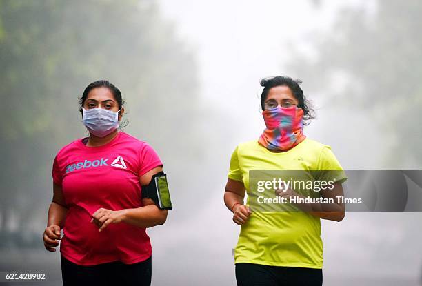 People jogging in a foggy morning at India Gate as smog covers the capital's skyline, on November 6, 2016 in New Delhi, India. New Delhi's air...