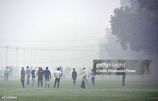 People play in a foggy morning at India Gate as smog covers the capital's skyline, on November 6, 2016 in New Delhi, India. New Delhi's air quality...