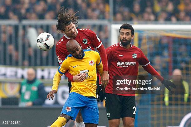 Dominik Kumbela of Braunschweig challenges Stefan Strandberg and Felipe Trevizan Martins of Hannover during the Second Bundesliga match between...