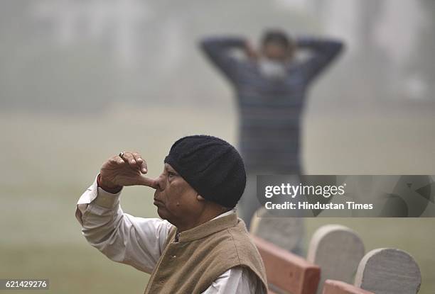 People doing their routine work in the polluted and foggy morning as smog covers the capital's skyline, on November 6, 2016 in New Delhi, India. New...