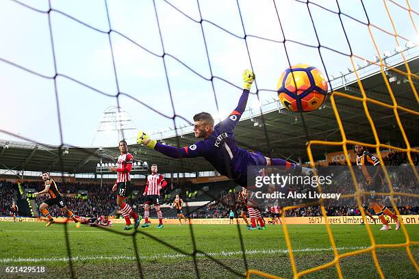 Fraser Forster of Southampton attempts to save as Robert Snodgrass of Hull City scores his sides first goal during the Premier League match between...