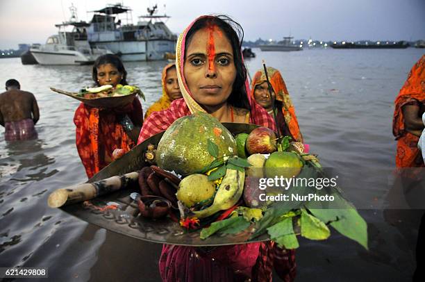 Indian Hindu devotees perform rituals during Chhat Puja while standing in the river in Kolkata on November 06,2016. Devotees pay obeisance to both...