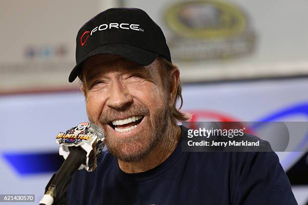 Actor Chuck Norris speaks with the media during a press conference prior to the NASCAR Sprint Cup Series AAA Texas 500 at Texas Motor Speedway on...