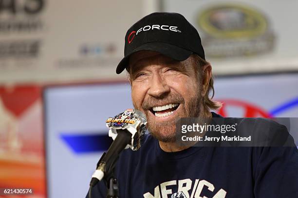 Actor Chuck Norris speaks with the media during a press conference prior to the NASCAR Sprint Cup Series AAA Texas 500 at Texas Motor Speedway on...