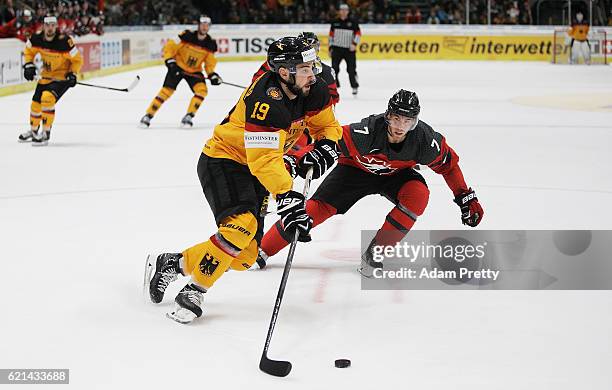 Thomas Oppenheimer of Germany is marked by Geoff Kinrade of Canada during the Germany v Canada Deutschland Cup 2016 Ice Hockey match at Curt Frenzel...