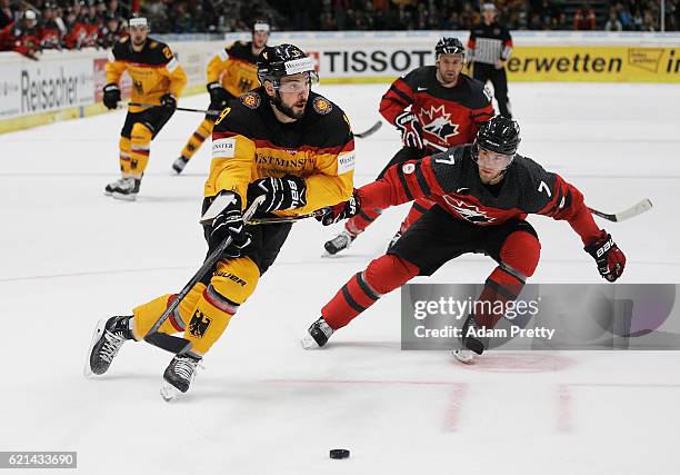 Thomas Oppenheimer of Germany is marked by Geoff Kinrade of Canada during the Germany v Canada Deutschland Cup 2016 Ice Hockey match at Curt Frenzel...