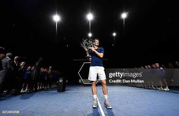 Andy Murray of Great Britain poses with 'Tree of Fanti' Trophy after winning the Mens Singles Final against John Isner of the United States on day...