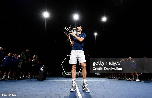 Andy Murray of Great Britain poses with 'Tree of Fanti' Trophy after winning the Mens Singles Final against John Isner of the United States on day...