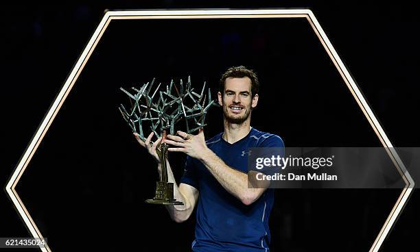 Andy Murray of Great Britain poses with 'Tree of Fanti' Trophy after winning the Mens Singles Final against John Isner of the United States on day...