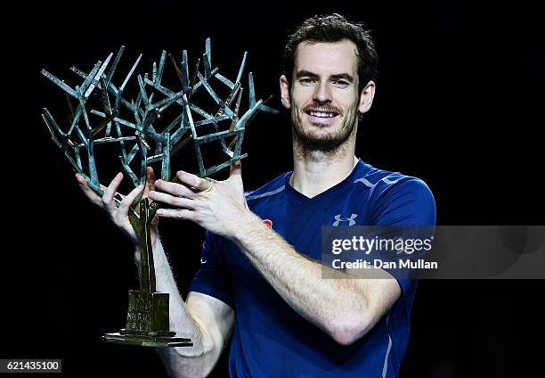 Andy Murray of Great Britain poses with 'Tree of Fanti' Trophy after winning the Mens Singles Final against John Isner of the United States on day...