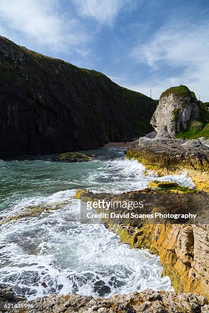 a rugged coastal landscape at ballintoy harbour along the causeway coast in antrim, northern ireland - northern ireland stock pictures, royalty-free photos & images