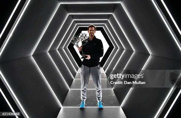 Andy Murray of Great Britain poses with 'Tree of Fanti' Trophy after winning the Mens Singles Final against John Isner of the United States on day...