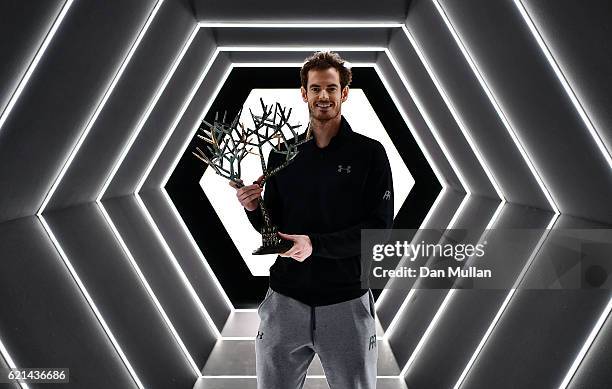 Andy Murray of Great Britain poses with 'Tree of Fanti' Trophy after winning the Mens Singles Final against John Isner of the United States on day...