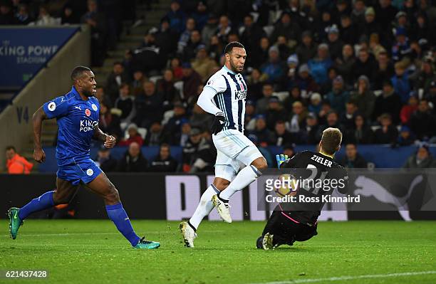 Wes Morgan of Leicester City closes down Matt Phillips of West Bromwich Albion as he chips Ron-Robert Zieler of Leicester City to score his sides...