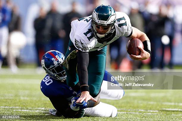 Jason Pierre-Paul of the New York Giants tackles Carson Wentz of the Philadelphia Eagles during the first quarter of the game at MetLife Stadium on...