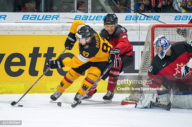 Brent Raedeke vies with Jonathan Sigalet during the Deutschland Cup between Germany and Canada on November 06 at Curt Frenzel Stadium in Augsburg,...