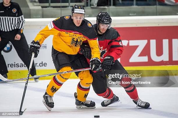 Jerome Flaake vies with Mat Robinson during the Deutschland Cup between Germany and Canada on November 06 at Curt Frenzel Stadium in Augsburg,...