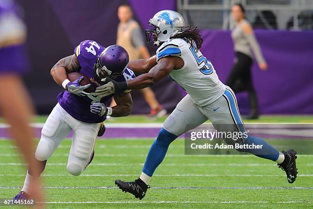 Matt Asiata of the Minnesota Vikings is tackled by Josh Bynes of the Detroit Lions during the first quarter of the game on November 6, 2016 at US...
