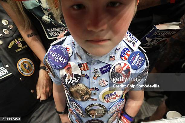 Mason Haliburton of Omaha, Nebraska, wears campaign buttons that he has collected from five different campaign rallies with Republican presidential...