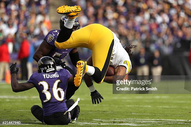 Tight end David Johnson of the Pittsburgh Steelers is tackled by cornerback Tavon Young of the Baltimore Ravens in the first quarter at M&T Bank...
