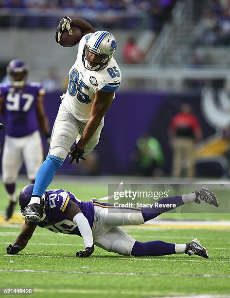 Eric Ebron of the Detroit Lions Mackensie Alexander of the Minnesota Vikings leaps over during the first half of the game on November 6, 2016 at US...