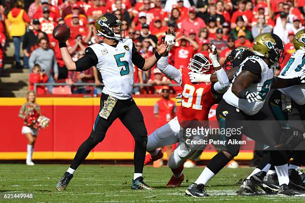 Quarterback Blake Bortles of the Jacksonville Jaguars throws a pass in front of the pass rushing outside linebacker Tamba Hali of the Kansas City...