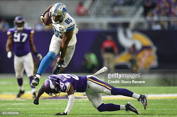 Eric Ebron of the Detroit Lions Mackensie Alexander of the Minnesota Vikings leaps over during the first half of the game on November 6, 2016 at US...