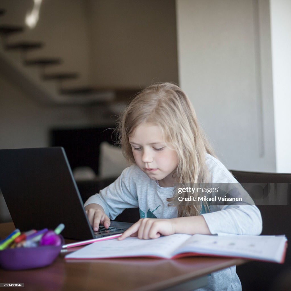 Doing Work Portrait Of Young Girl Doing Her School Work With Laptop High-Res Stock ...