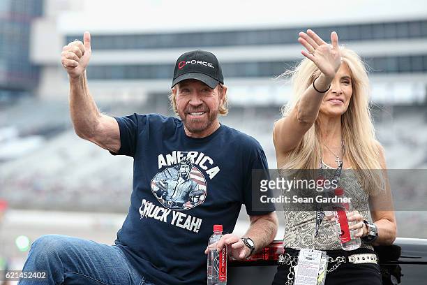 Actor Chuck Norris and his wife, Gena O'Kelley, wave to fans during driver introductions prior to the NASCAR Sprint Cup Series AAA Texas 500 at Texas...