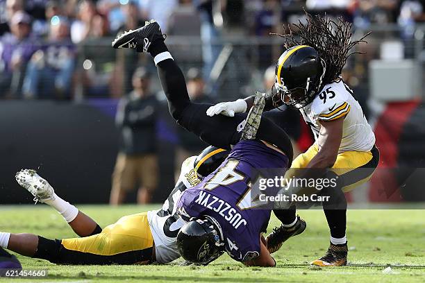 Fullback Kyle Juszczyk of the Baltimore Ravens is tackled by inside linebacker Ryan Shazier and outside linebacker Jarvis Jones of the Pittsburgh...