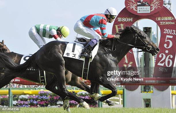 Fuchu, Japan - Kizuna , the race favorite ridden by Yutaka Take, crosses the finish line to win the 80th Japanese Derby, the second leg of the...