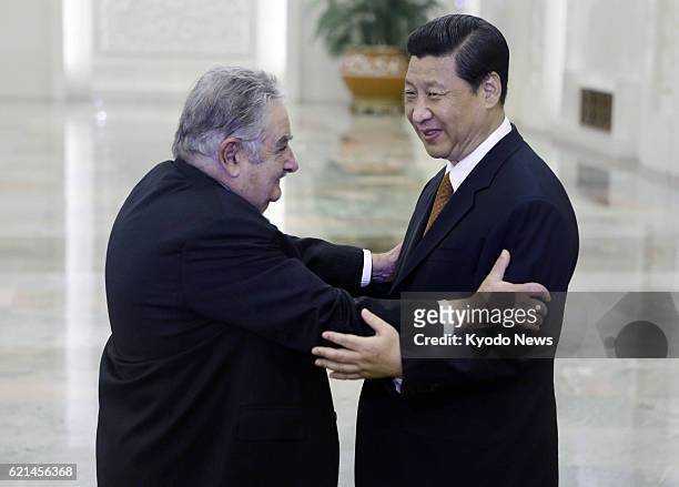 China - Uruguayan President Jose Mujica and Chinese President Xi Jinping greet each other at the Great Hall of the People in Beijing on May 27, 2013.