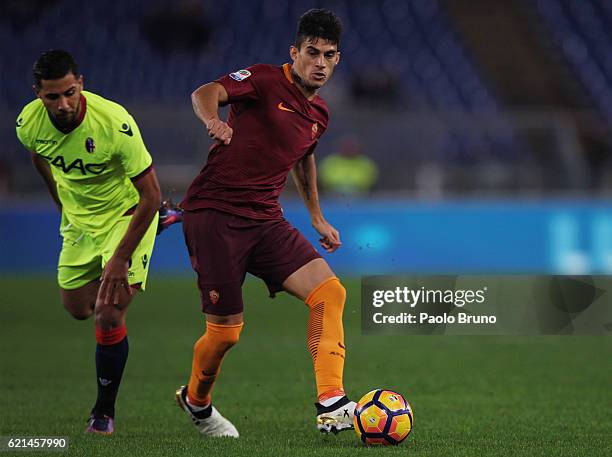 Diego Perotti of AS Roma competes for the ball with Saphir Taider of Bologna FC during the Serie A match between AS Roma and Bologna FC at Stadio...