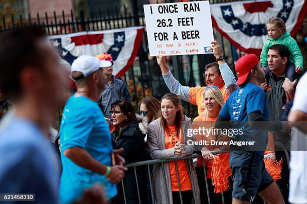 Supporter holds a sign as runners make their way north on First Avenue during the 2016 TCS New York City Marathon, November 6, 2016 in New York City....