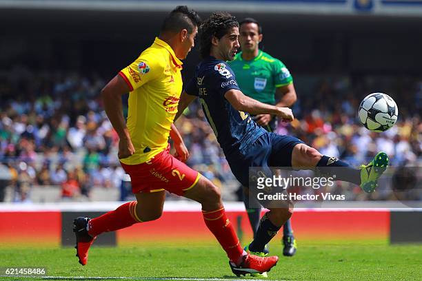 Enrique Perez of Morelia fights for the ball with Matias Britos of Pumas during the 16th round match between Pumas UNAM and Morelia as part of the...