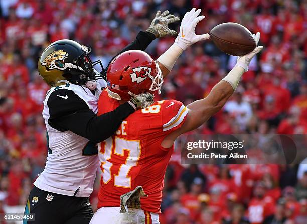 Tight end Travis Kelce of the Kansas City Chiefs goes up to catch a pass in the end zone covered by cornerback Prince Amukamara of the Jacksonville...