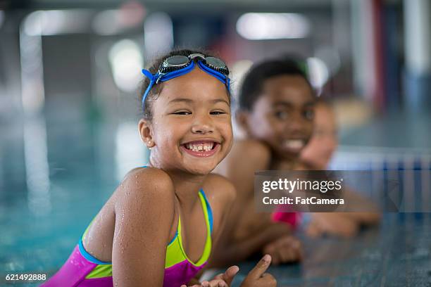 children taking swimming lessons - leisure facilities stock pictures, royalty-free photos & images