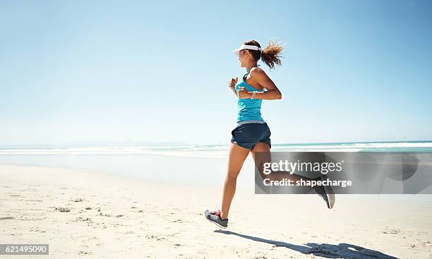 enjoying the beauty of the beach while working out - women running stock pictures, royalty-free photos & images