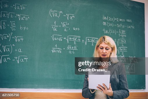 Math Professors Desk Female Math Professor In Classroom With Digital Tablet High-Res Stock ...
