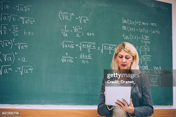 female math professor in classroom with digital tablet - algebra stock pictures, royalty-free photos & images