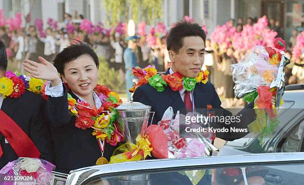 North Korea - North Korean table tennis players Kim Hyok Bong and Kim Jong parade aboard a convertible in Pyongyang on May 30 after they won the...